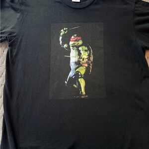 Supreme Raphael Tee in black from the Spring/Summer 2021 collection